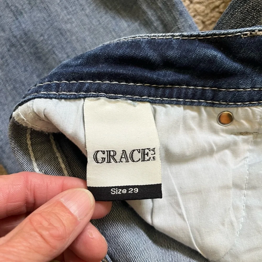 Grace in LA bootcut blue jeans with sequin and embroidery designs. Women’s 29